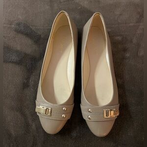 Nine West tan leather ballet flats size 5 1/2 women’s with gold tone buckles.